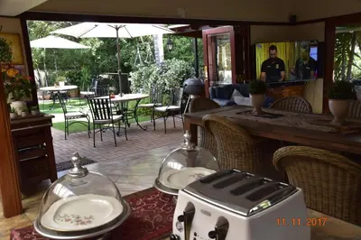a table with a toaster and plates on it at Lamor Guest House in Middelburg