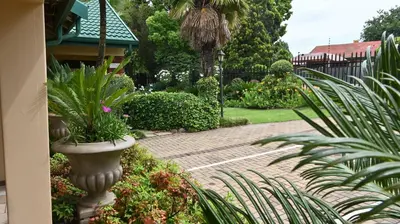 a garden with a large vase with plants in it at Lamor Guest House in Middelburg
