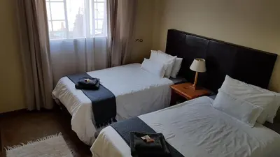 a hotel room with two beds and a window at 298 on 34th in Pretoria