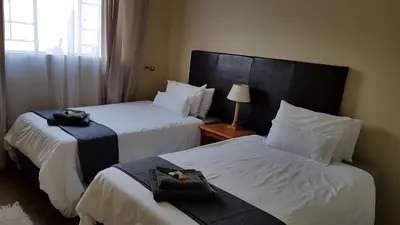 a hotel room with two beds with towels on them at 298 on 34th in Pretoria