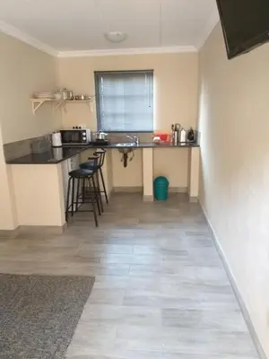 a small kitchen with a counter and a table at 298 on 34th in Pretoria