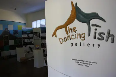 a sign for the dancing fish gallery in a room at Madi a Thavha Mountain Lodge in Louis Trichardt
