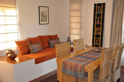 a living room with a table and a couch at Madi a Thavha Mountain Lodge in Louis Trichardt