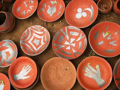 a group of red plates sitting on the ground at Madi a Thavha Mountain Lodge in Louis Trichardt