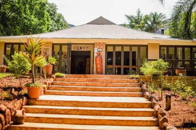 a building with stairs in front of a building at Madi a Thavha Mountain Lodge in Louis Trichardt