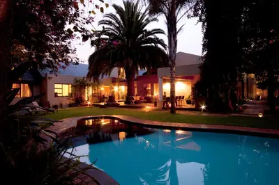 a swimming pool in the yard of a house at African Rock Hotel & Spa, a 