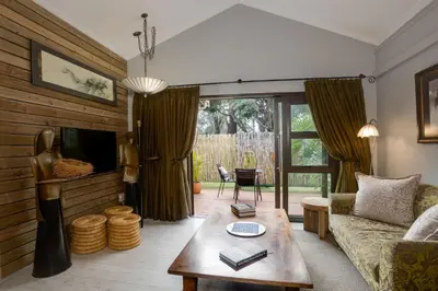 a living room with a couch and a table at African Rock Hotel & Spa, a 