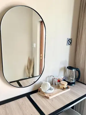 a mirror on top of a table with a tray at Lighthouse Guesthouse & Cafe in Groblersdal