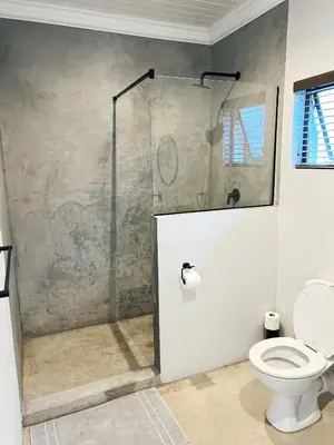 a bathroom with a shower and a toilet at Lighthouse Guesthouse & Cafe in Groblersdal