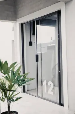a sliding glass door with the number on it at Lighthouse Guesthouse & Cafe in Groblersdal