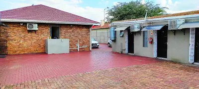 a brick building with a red brick driveway at Sir Pinto Guesthouse in Witbank