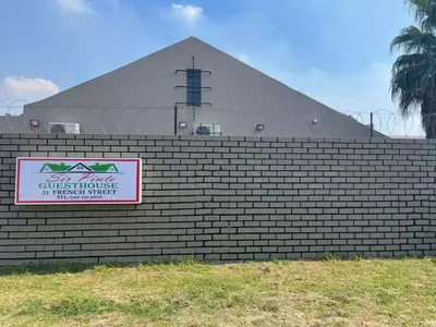 a sign on a brick wall in front of a pyramid at Sir Pinto Guesthouse in Witbank