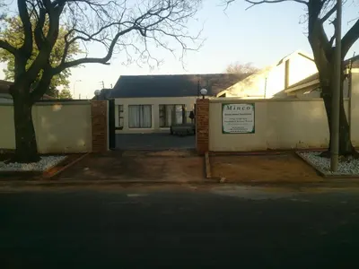 a house with a sign in front of it at Minco Guesthouse in Kempton Park