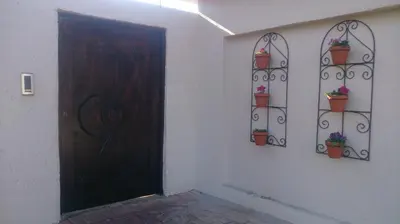 a room with a door and potted plants on the wall at Minco Guesthouse in Kempton Park