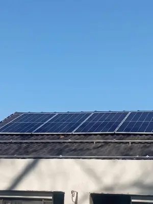 a group of solar panels on the roof of a building at Minco Guesthouse in Kempton Park