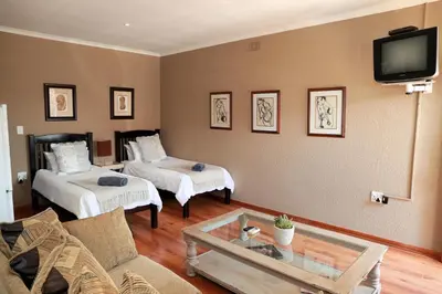 a living room with two beds and a tv at Big 