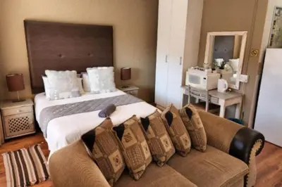 a bedroom with a large bed and a couch at Big 