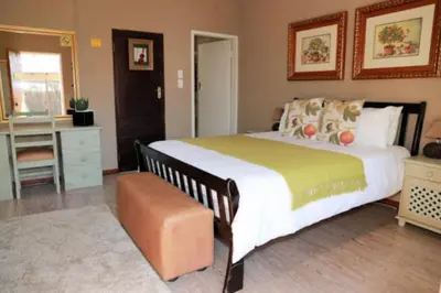 a bedroom with a large bed and a desk at Big 