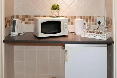 a microwave sitting on top of a counter in a kitchen at Big 