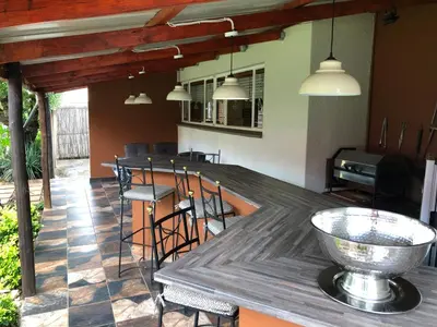 a patio with a wooden table and chairs at Big 
