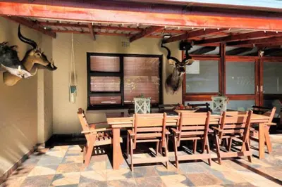 a dining room with a table and some animals on the wall at Big 