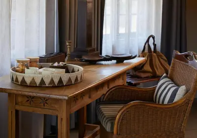 a table with a tray of food on it with two chairs at Motswari Private Game Reserve by NEWMARK in Timbavati Game Reserve
