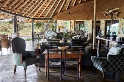 a living room with couches and a table and chairs at Motswari Private Game Reserve by NEWMARK in Timbavati Game Reserve