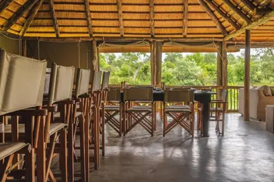a group of chairs and tables in a tent at Shindzela Tented Camp in Timbavati Game Reserve