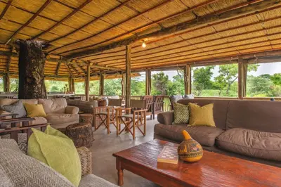 a living room with couches and a table at Shindzela Tented Camp in Timbavati Game Reserve