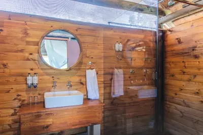 a bathroom with a sink and a mirror at Shindzela Tented Camp in Timbavati Game Reserve