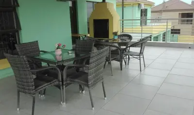 a patio with a table and chairs on a balcony at Estoby Executive guest house in Witbank