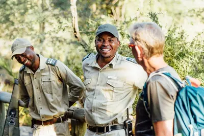 a group of three men standing next to a woman at Tanda Tula Safari Camp in Timbavati Game Reserve