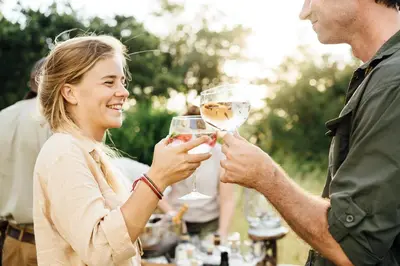 a man and woman holding glasses of wine at Tanda Tula Safari Camp in Timbavati Game Reserve