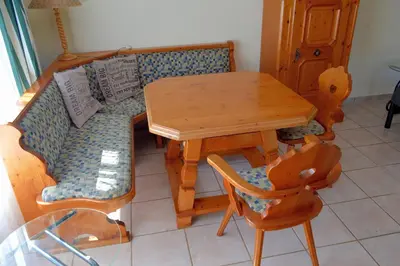 a living room with a couch and a table and chairs at Holiday Flat Stormvoel 547 in Hazyview