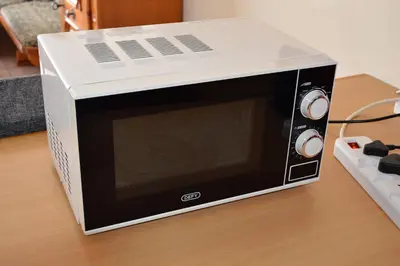 a microwave oven sitting on top of a table at Holiday Flat Stormvoel 547 in Hazyview
