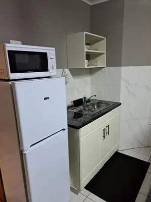 a kitchen with a microwave on top of a refrigerator at Horizon View Chalets in Graskop