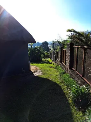 a path leading to a building with a fence at Horizon View Chalets in Graskop