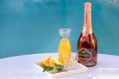a bottle of wine and a glass of orange juice at Brooklyn Manor in Pretoria