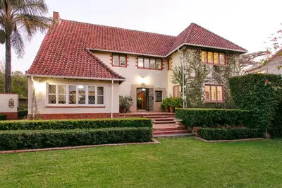 a white house with a red roof at Brooklyn Manor in Pretoria