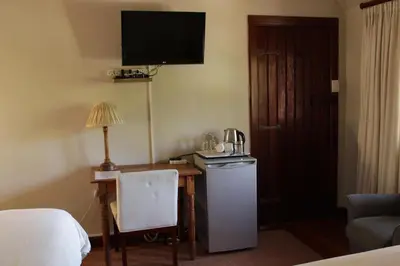 a hotel room with a desk with a coffee maker on it at Brooklyn Manor in Pretoria
