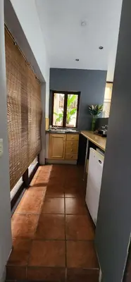 a kitchen with a tiled floor and a counter top at Bali at Scenic Haven Lodge in Hartbeespoort in Hartbeespoort