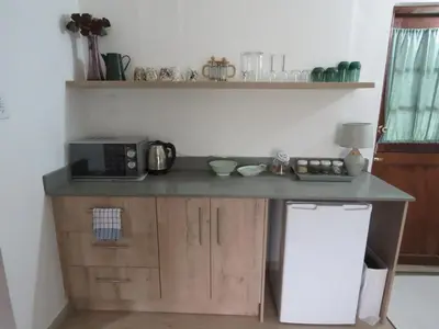 a kitchen with a counter with a microwave on it at Nightjar Guest Lodge in Nelspruit