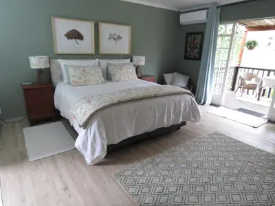 a bedroom with a large bed in a room at Nightjar Guest Lodge in Nelspruit