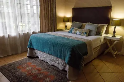 a bedroom with a large bed and a window at Irene B&B in Irene