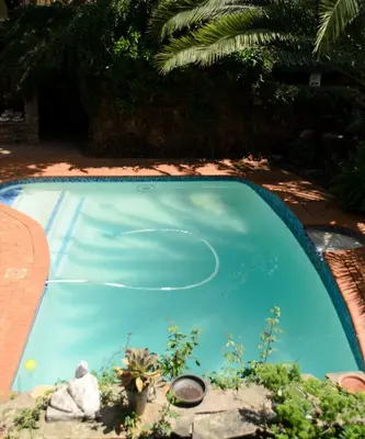 a swimming pool with blue water in a yard at Irene B&B in Irene