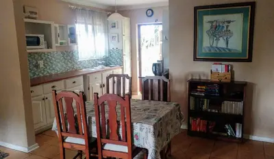 a kitchen with a table with two chairs and a counter at Irene B&B in Irene