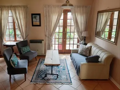 a living room with a couch and a table at Irene B&B in Irene