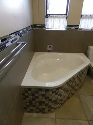a large bath tub in a bathroom with a window at Lion King in Marloth Park
