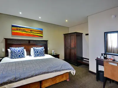 a hotel room with a bed and a television at ANEW Hotel Witbank Emalahleni in Witbank