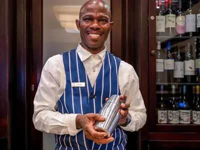 a man holding a can in a wine cellar at ANEW Hotel Witbank Emalahleni in Witbank